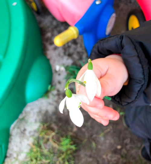 Et barn holder en blomst